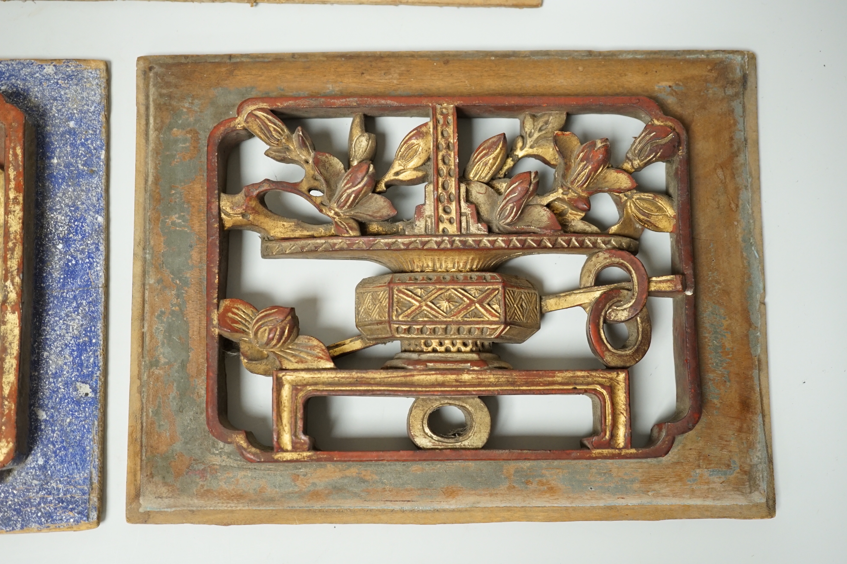 Three Chinese gilded and lacquered wood panels, early 20th century, longest 31cm